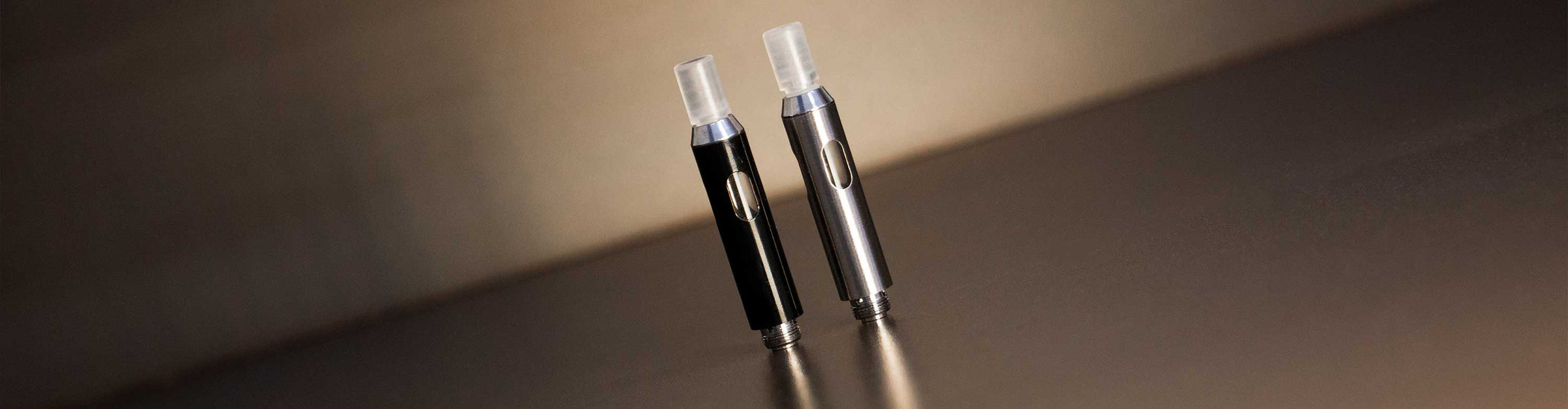 Vaporizer Tanks standing together on top of office table inside building with spotlight
